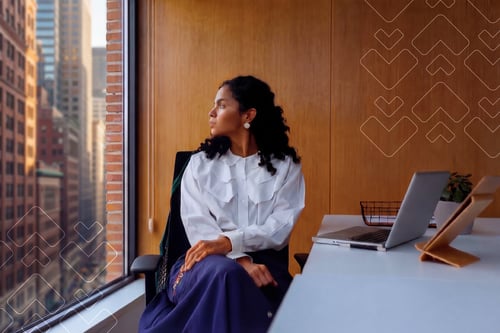 Concerned Business Woman looking out window onto city